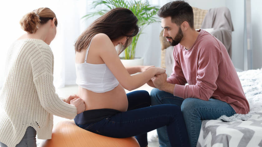 Pregnant couple with doula at home