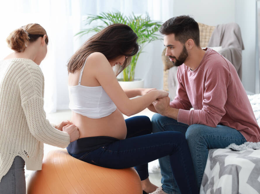 Pregnant couple with doula at home